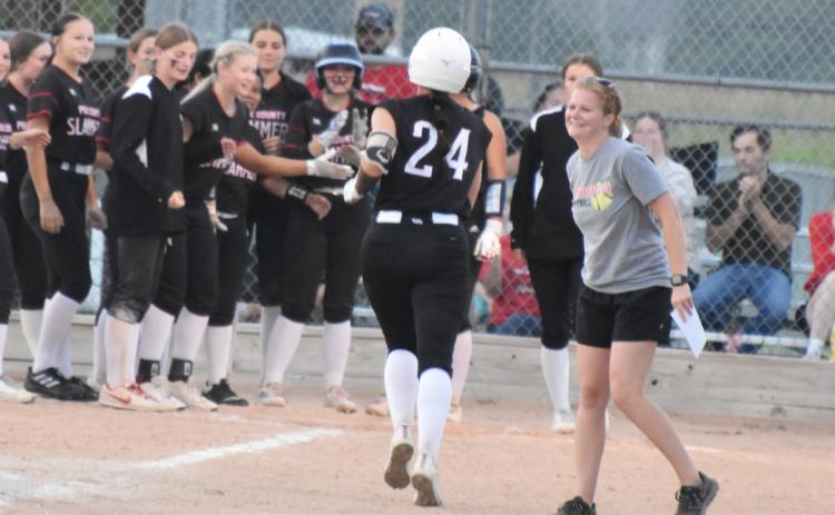 Polk County’s Adrienne Waller (24) is congratulated by co-head coach Macy Jones after hitting one of her two home runs against Twin River. PCN photo by Beth Sparrow