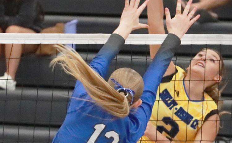 Top left- Kierslyn Cattaau hammers the attack against the Malcolm front line. Top right- Sophomore Hayden Hopwood keeps the ball in play during action against Malcolm. PCN photos by Ken Kush