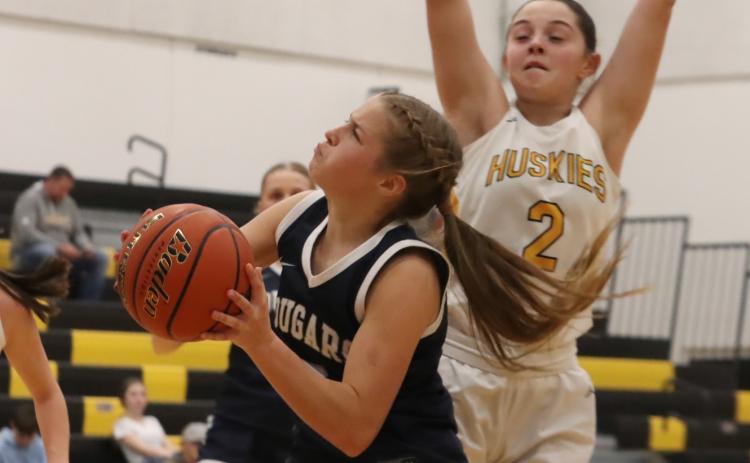 Cougar’s sophomore Olive Peterson (10) works inside with Shelby-RC’s Patience Spitz (2) providing the defense for the Huskies. PCN photo by Ken Kush.