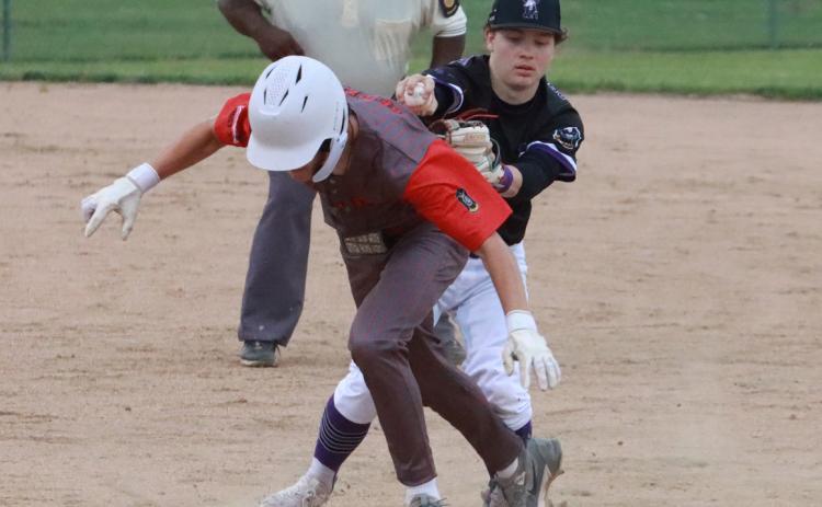 SOS second baseman Ruger Webb completes the run down by tagging the Valpariaso runner out during action last Thursday night in Osceola. PCN photo by Ken Kush.