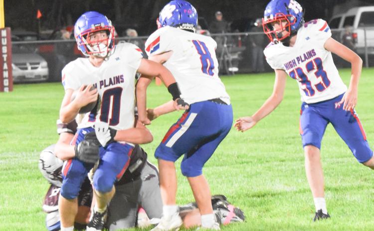 High Plains quarterback Carson Swedenburg tries to escape the grasp of the Silver lake defender in Friday night prep gridiron action. PCN photo by Beth Sparrow.