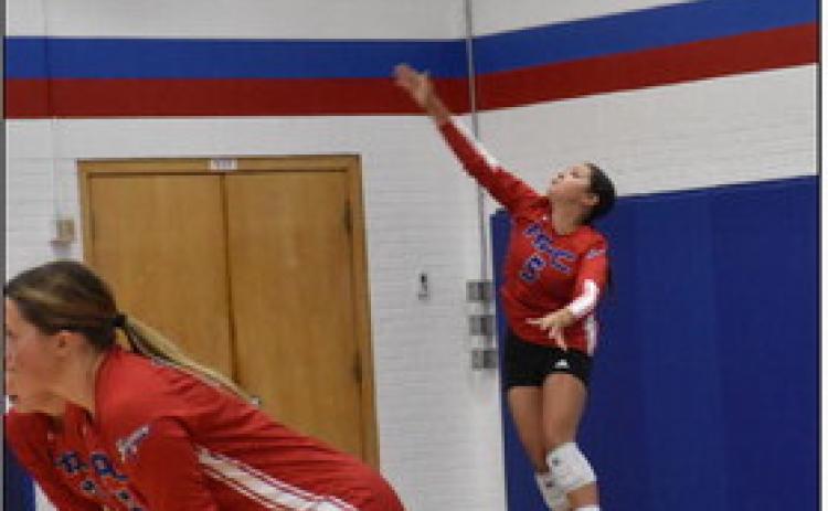 Gahvi Lesiak serves one over earlier this season. PCN file photo by Beth Sparrow.