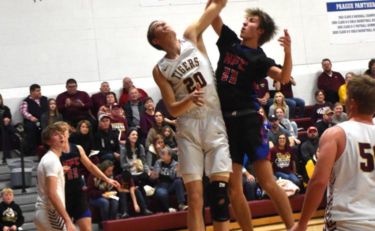 Carter Urkoski (HPC) fights Brody Johnson (EB, 6’11) for the rebound. PCN photo by Beth Sparrow.