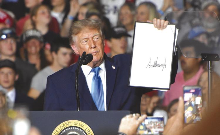 Above: President Donald Trump came to Grand Island, Nebraska to promote Republican candidates Pete Ricketts, Gov. Jim Pillen and the three Congressional representatives. Here he holds up his signed presidential order to make red diesel tax free. PCN photo by Beth Sparrow