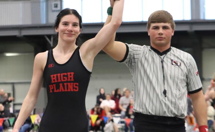 High Plains senior Dakota Gress gets her hand raised after defeating Aurora’s Di Maria Leininger for her 100th career win on Thursday. Dakota finished second overall at 135 pounds. PCN photo by Ken Kush.