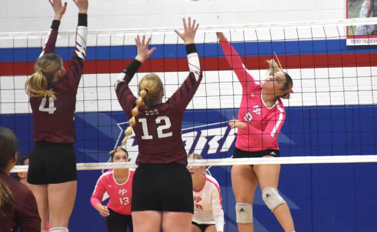 The Storm’s HallieJo Urloski (9) tries to split the block of BDS’ front line on her attack. PCN photo by Beth Sparrow