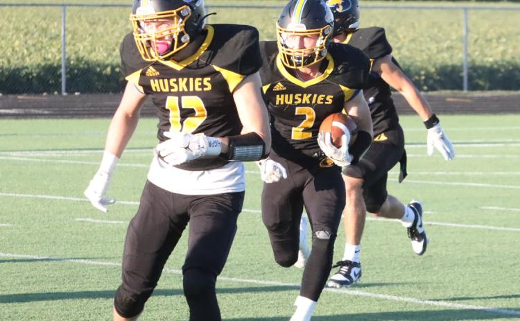 Shelby-RC junior quarterback Logan Lindsley (2) runs behind fellow junior Jett Vrbka (12) in the win over Sandy Creek. Lindsley ran for three scores in the teams win at Heartland Friday night. PCN file photo by Ken Kush.