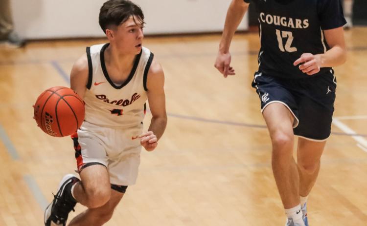 Brayden Santos (left, Osceola) tries to beat Thatcher Hanson (right, Cross County) down the court. PCN photo by Blaine Winslow.