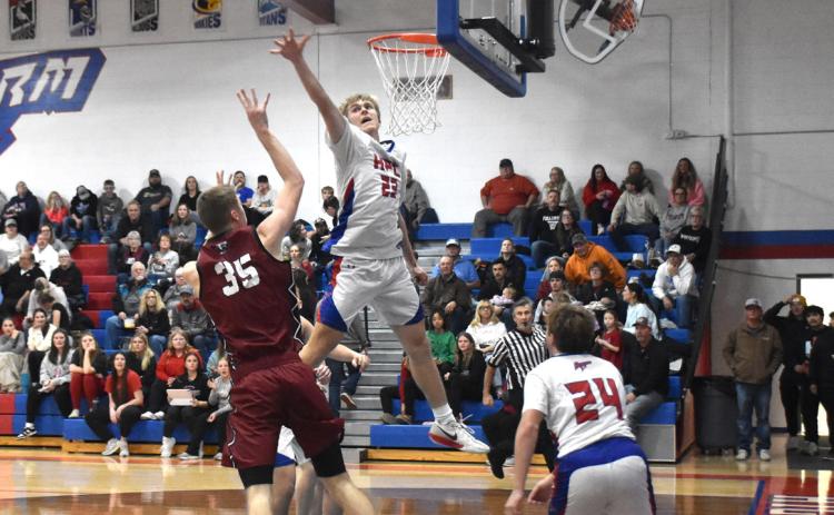 Storm senior Brodey Spurling skies as he tries to block the Fullerton Warriors shot attempt. PCN photo by Beth Sparrow.