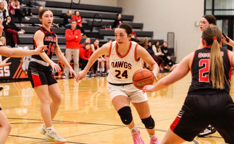 Osceola junior Bella Recker (24) has her eyes peeled towards the basket as she drives during the loss to David City on friday night. PCN photo by Blaine Winslow.