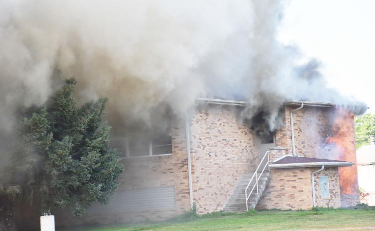 The Sacred Heart School in Shelby was burned down in a controlled burn on Monday night. Smoke and flames can be seen as the structure was removed to make space for a new building. PCN photos by Beth Sparrow.