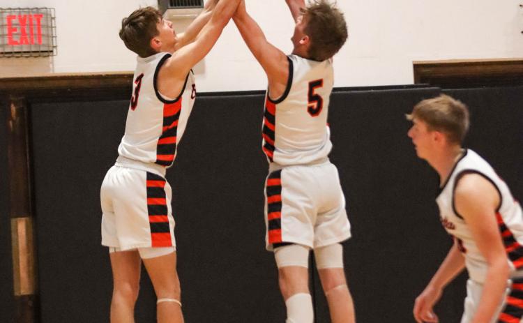 Kelby Neujahr and Boston Hinkle fight over a rebound as Braxton Mestl watches. PCN file photo by Blaine Winslow.