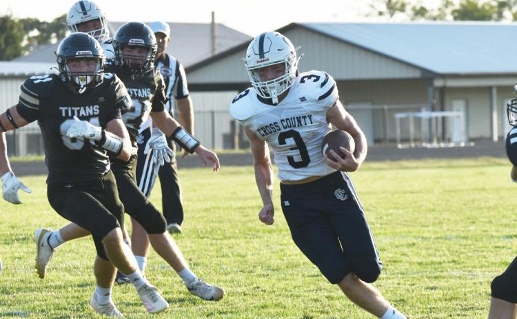Cross County junior quarterback Eli Greenwall (3) turns the corner against the Thayer Central defense last Friday night in Hebron. Greenwall ran for three scores, returned a kickoff and finished with 156 yards on the ground. PCN photo by Beth Sparrow.