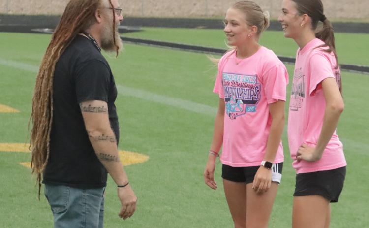 Shelby-RC head coach Cory Waite talks to both Danica Watts (left) and Danica’s training partner Leah Whitmore (right) during Monday’s workout. PCN photo by Ken Kush.