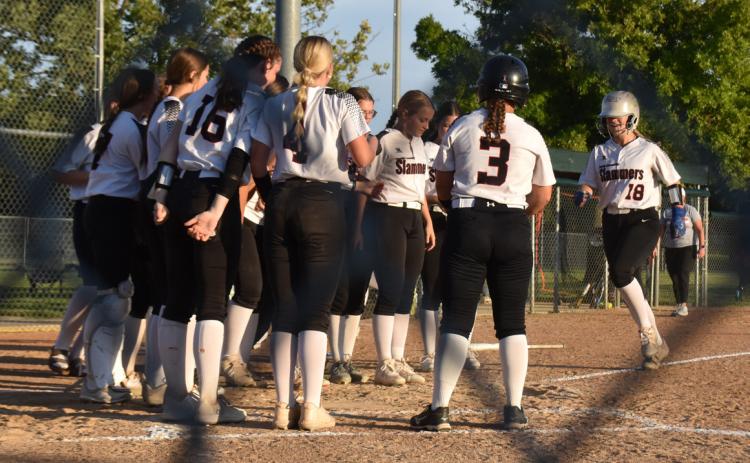 Above-As a junior Polk Counties Mady Berggren hammered four home runs. Here she is greeted by her teammates at home plate after going yard in the team’s game with Central City. PCN file photo.