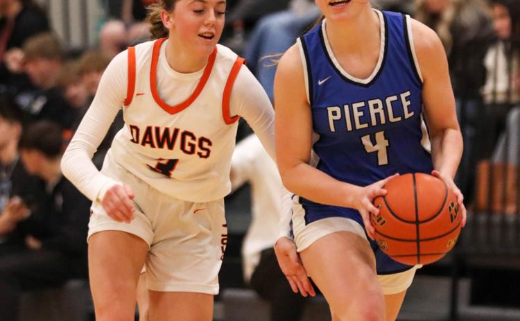 Osceola’s Kalisyn Prososki tries to keep the pace with Emily Endorf during Friday’s game in Osceola. PCN photo by Blaine Winslow.