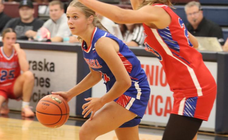 Top-Cross County’s Eden Peterson competed on the Red team during the Nebraska Coaches All-Star Game last week at Lincoln North Star. Photo by Christian Horn. Right- Peterson and CC coach Mitch Boshart. Photo was provided.