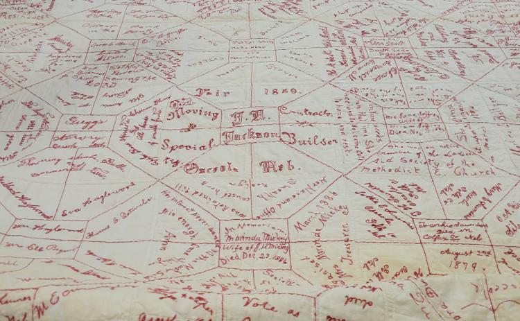 This souvenir quilt from 1889 will be on display at the church with others on September 10th at the Polk County Museum. Photo by Beth Sparrow.