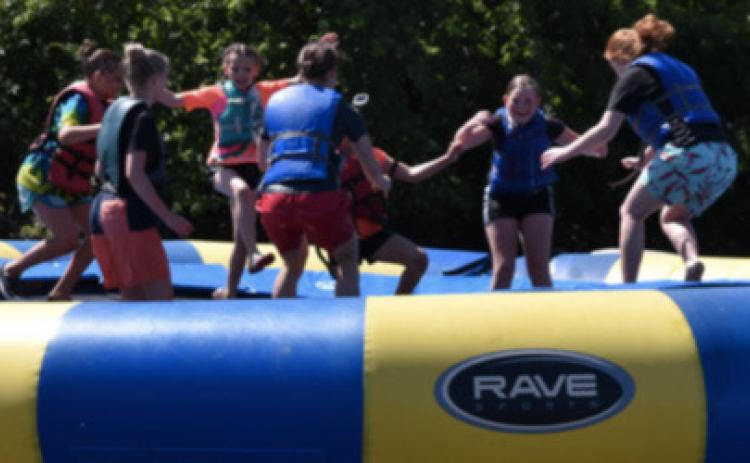 Kids at Royal Family Kids camp have fun on a large intertube at camp. Photo provided.