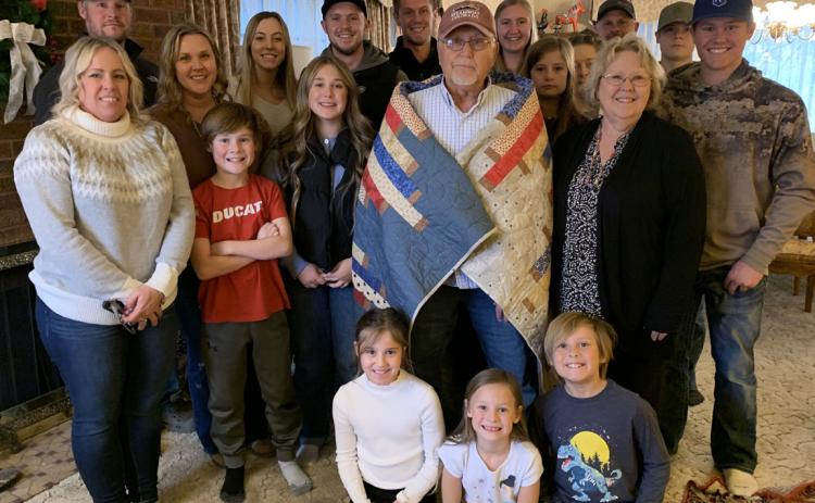 Jerry Werth (center, wearing quilt) was honored for his service to our country with a Quilt of Valor and a Vietnam Commemorative lapel pin. He is pictured with his family. Photo provided.