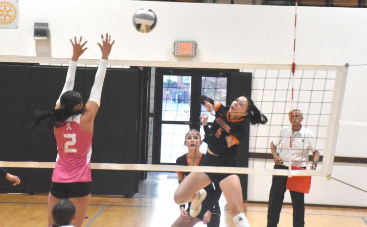 Osceola senior Camryn Peterson (5) tries to attack up and over the Dorchester defense in Saturday’s first round match with the Longhorns in York. PCN photo by Beth Sparrow