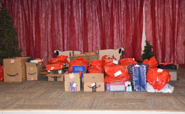 Gifts sit on the Salem Lutheran stage waiting to be wrapped by church volunteers. PCN photo by Beth Sparrow.