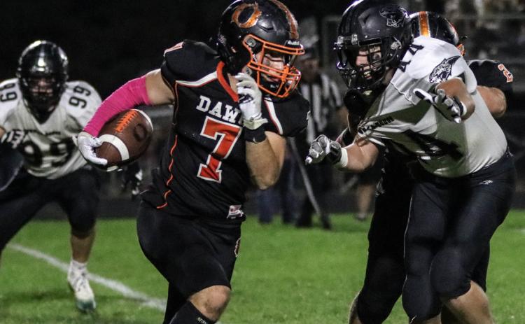 Aden Feezell runs the ball and tries to avoid the tackler. PCN photo by Blaine Winslow.