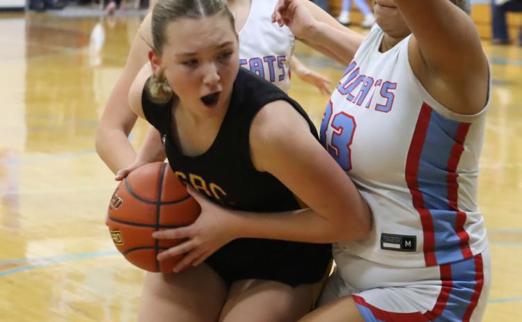 Shelby-RC freshman Hayden Hopwood muscles the ball into the paint where she draws the foul on Cedar Bluff’s Jakiah McCoy during Friday’s game in Cedar Bluffs. Hopwood finished with 21 points in the Huskies win. PCN photo by Ken Kush.