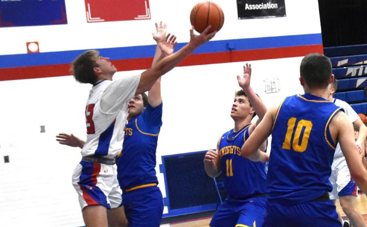 Carter Urkoski goes up for the basket against Knight defenders. PCN photo by Beth Sparrow