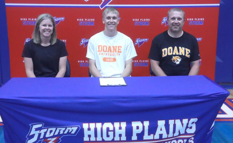 With his mom Nikki to his right and his dad Nate to his left, Brodey Spurling signed to play basketball at Doane University last Friday at High Plains High School. PCN photo by Ken Kush.