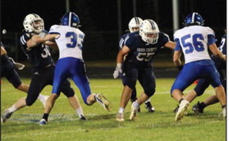 Above: Alex Noyd (right) blocks while Izaac Dickey (left) and a Titan fight for dominance. PCN photo by Travis Lane.