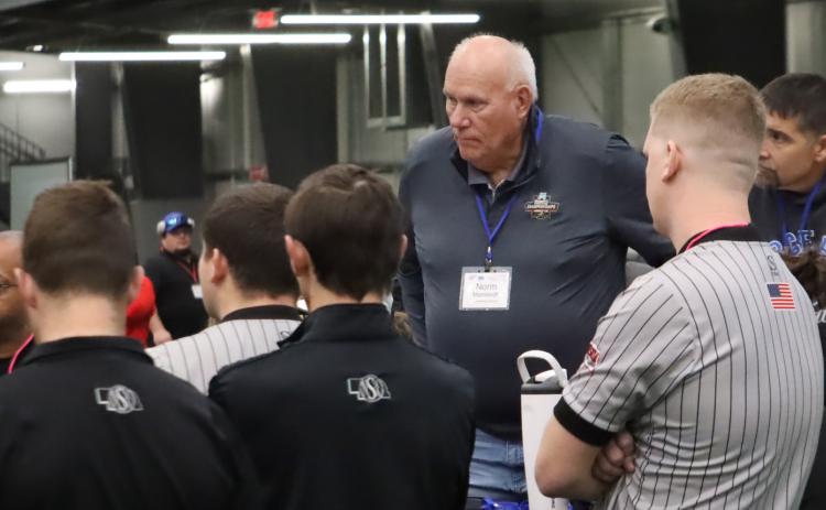 Former High Plains head wrestling coach Norm Manstedt (center) listens in on the officials meeting just before the start of the Norm Manstedt Girls Invitational on Thursday. PCN photo by Ken Kush.