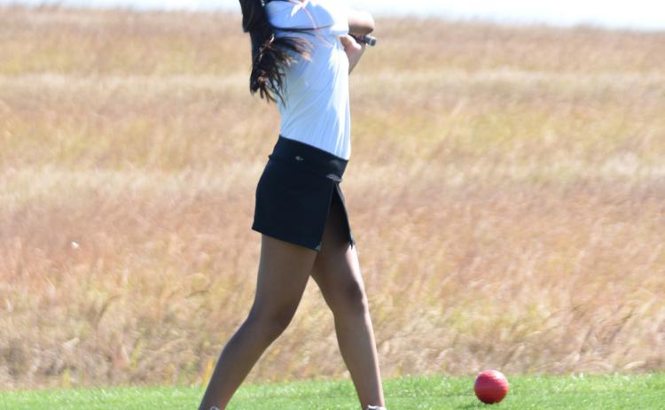 Above: Xitlaly Quintana looks for her ball after teeing off. Photo provided by SRC yearbook.