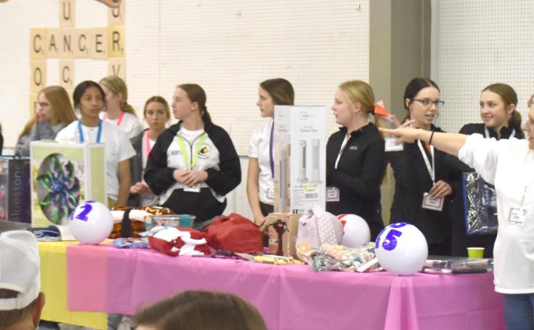 Polk County Health Department hands out door prizes with help from Osceola and Shelby-Rising City cheer teams. PCN photos by Beth Sparrow