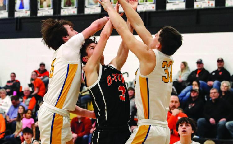Kelby Neujahr tries to shoot while Blake Schmidt and Dylan Micek defend. PCN photo by Blaine Winslow.