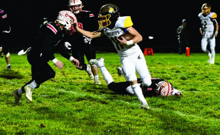 Carter Eickmeier runs the ball around some Cougar defenders. PCN photo by Rick Holtz.