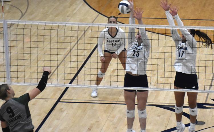 Hadley Larson (left) and Saphira Osentowski (right) try to block a Jaguar kill as Edie Peterson awaits her chance. PCN photo by Beth Sparrow.