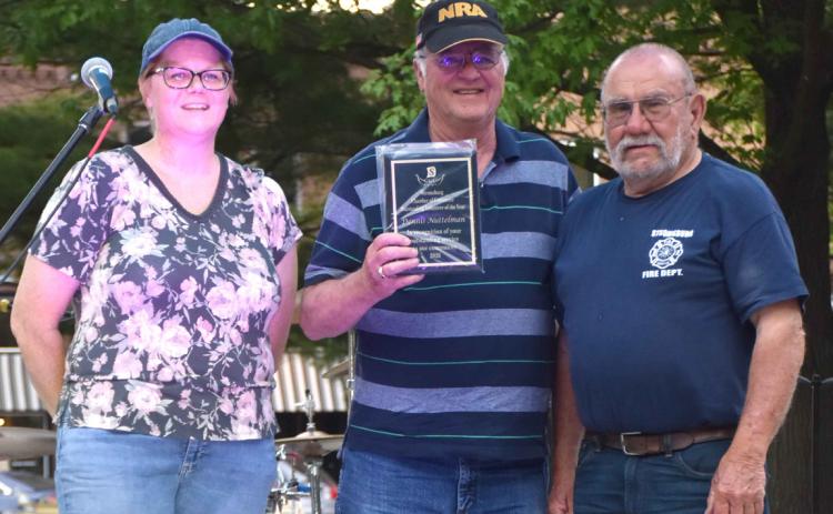 Above: Hillary Mundt and Mayor Ken Everingham present Dennis Nuttelman with the volunteer of the year.