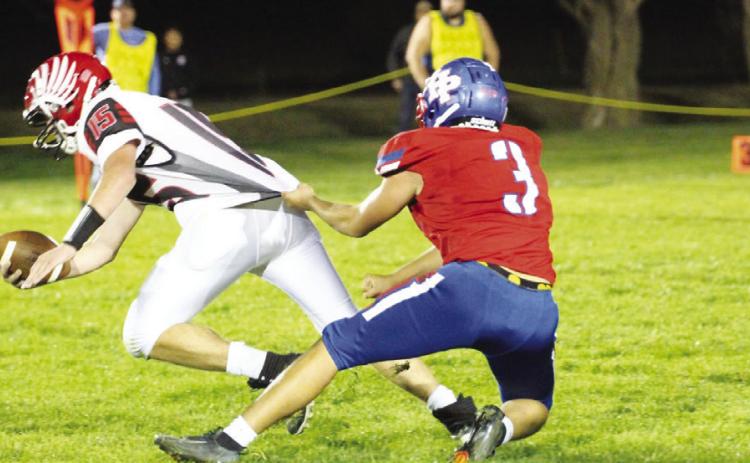 Top- Bowdy Glasser hangs on to the Harvard ball carrier. Above-Aaron Brown finds running room against Harvard on Friday. PCN photos by Travis Lane.