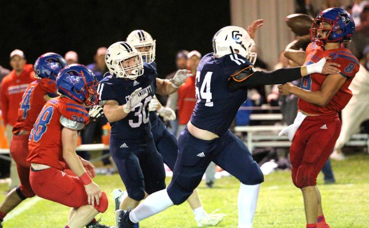 Dane Holtzen defends against the Clarkson-Leigh quarterback throwing the football while Izaac Dickey backs him up. PCN photo by Travis Lane.
