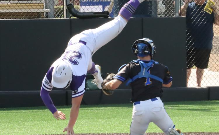Left- SOS Rebel Senior Eli Fjell (21) tries to go up and over Seward catcher Bostyn Happ (1) during Saturday’s game at Levitt Stadium in York during B-4 District action. Fjell’s attempt to avoid the tag was unsuccessful.