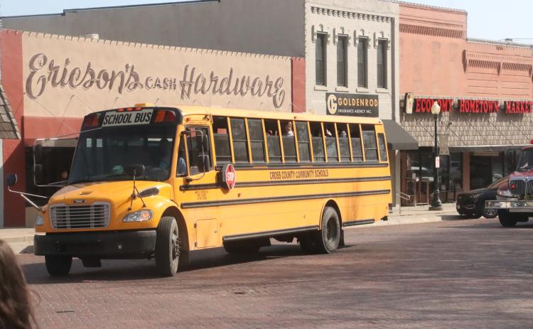 Four years in a row the Cross County Cougars girls basketball team had made the Nebraska State Basketball tournament in Lincoln. Here the bus loaded with the team cruises through downtown Stromsburg on Thursday, March 5 as people gathered to see the girls off and wish them luck. PCN photo by Ken Kush.