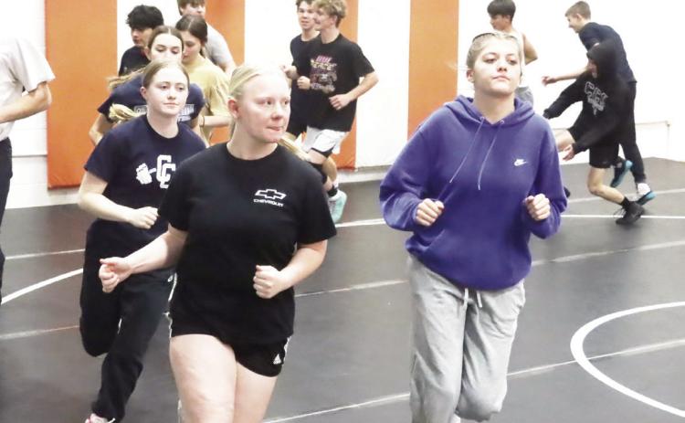 The Cross County/Osceola Twisters girls wrestling team gets in their running at Tuesday’s practice held at the Osceola Auditorium. Both the girls and the boys teams are practicing at the Auditorium at the same time. PCN photo by Ken Kush.