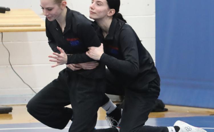 Bailey (left) and Dakota (right) work out before the start of the B-2 District at Columbus Lakeview. They are the only members of the High Plains girls team and both qualified for the state meet last weekend. PCN photo by Ken Kush.