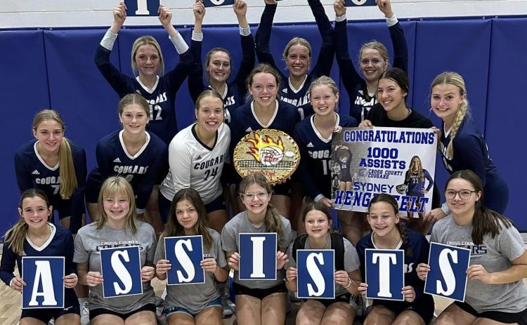 Cross County volleyball celebrates with Sydney Hengelfelt (center) on her 1000th assist last week. Photo provided.