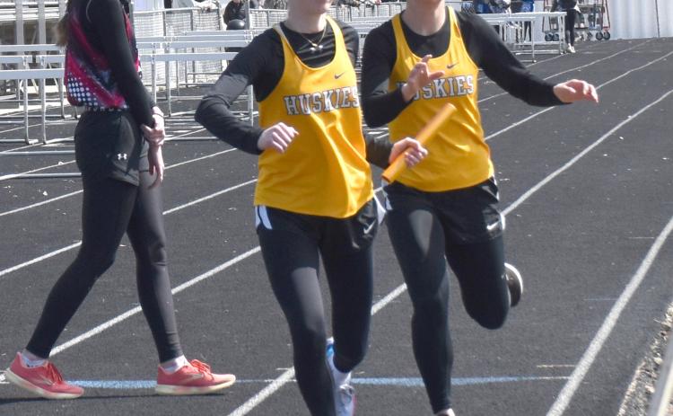 Ellie Frederick takes the handoff from Angel Barnes in the 4x800-meter relay. PCN photos by Beth Sparrow