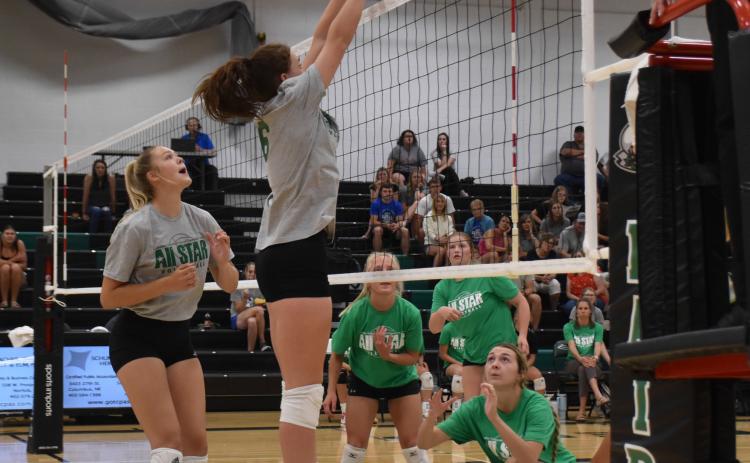 Above: Kenzie Wruble goes up for the block. Below: Liberty Baker hits a jump serve for the green team. PCN photos by Beth Sparrow.