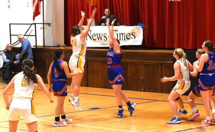 Rylie Carter shoots one for Shelby-Rising City over the arms of Allie Howell of High Plains. PCN photo by Cienna Friesen.