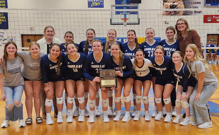 Left: Cross County volleyball team with their district winner plaque.