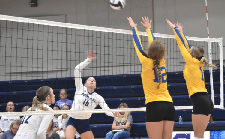 Ava Pruter (CC) hits one by the block of Brea Schaefer and Mackenzie Kuns (SRC). PCN photo by Kirk Sparrow.